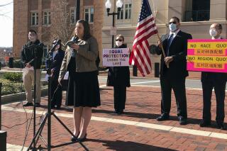 FILE - In this March 10, 2021 file photo, Pacific Legal Foundation attorney Erin Wilcox speaks at a news conference outside the federal courthouse, in Alexandria, Va., where her organization filed a lawsuit against Fairfax County's school board, alleging discrimination against Asian Americans over its revised admissions process for the elite Thomas Jefferson High School for Science and Technology. A federal judge ruled Friday, May 21 that a parents' group can move forward with the lawsuit. (AP Photo/Matthew Barakat, File)