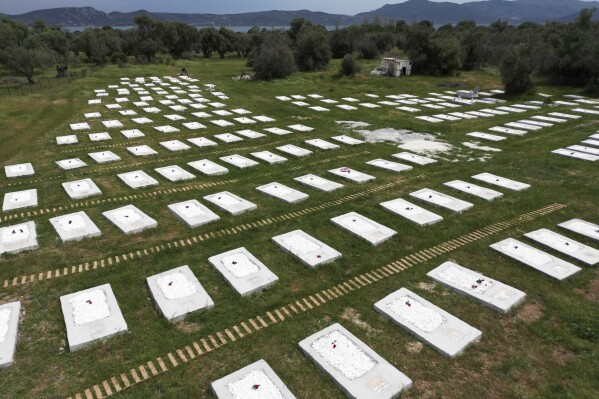 A cemetery is seen from above at Kato Tritos village on the northeastern Aegean Sea island of Lesbos, Greece, on Wednesday, April 17, 2024. After years of neglect, a primitive burial ground for refugees who died trying to reach Greece's island of Lesbos has been cleaned up and redesigned to provide a dignified resting place for the dead. (AP Photo/Panagiotis Balaskas)