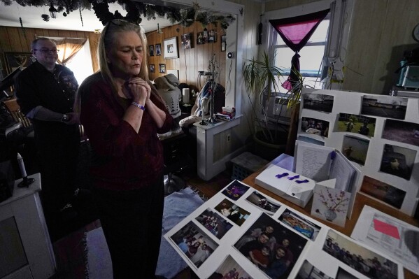 Trina Cotter holds up a pendant holding some of the ashes of her son, Zach Robinson, during an interview at her family home on Thursday, Nov. 30, 2023, in Dover, N.H. Robinson endured decades of nightmares about being raped. Tried to fight.  Child in New Hampshire youth detention center.  He died last November, still awaiting accountability for his alleged abusers.  (AP Photo/Charles Krupa)