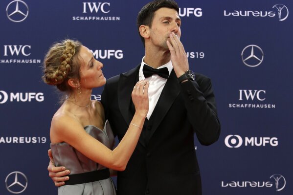 FILE - In this Monday, Feb. 18, 2019 file photo Serbian tennis player Novak Djokovic and his wife Jelena arrive for the 2019 Laureus World Sports Awards. Novak Djokovic has tested positive for the coronavirus after taking part in a tennis exhibition series he organized in Serbia and Croatia. The top-ranked Serb is the fourth player to test positive for the virus after first playing in Belgrade and then again last weekend in Zadar, Croatia. His wife also tested positive. (AP Photo/Claude Paris, File)