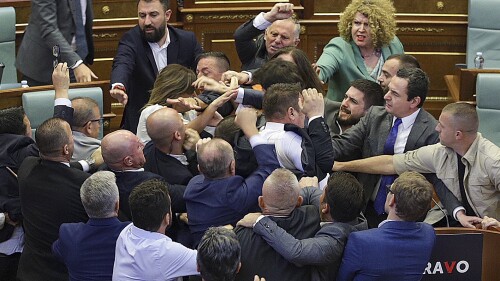 Lawmakers push each other as a brawl breaks out in Kosovo's parliament in Pristina, Kosovo, Thursday, July 13, 2023. A brawl erupted in the Kosovo parliament on Thursday after an opposition lawmaker threw water on Prime Minister Albin Kurti while he was speaking about government measures to defuse tensions with ethnic Serbs in the country's north. Kosovo opposition parties have criticized Kurti's policies in the north that have strained relations with key Western allies. (AP Photo/Ridvan Slivova)