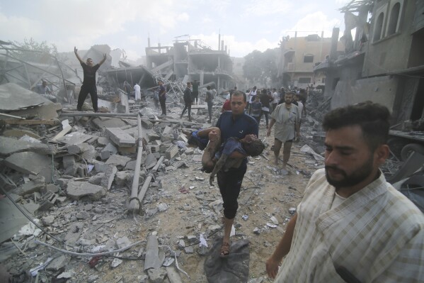 Palestinians evacuate wounded in the Israeli bombardment of Rafah, southern Gaza Strip, Tuesday, Oct. 17, 2023. (AP Photo/Hatem Ali)