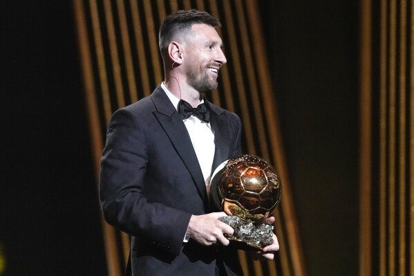 Inter Miami's and Argentina's national team player Lionel Messi receives the 2023 Ballon d'Or trophy during the 67th Ballon d'Or (Golden Ball) award ceremony at Theatre du Chatelet in Paris, France, Monday, Oct. 30, 2023. (AP Photo/Michel Euler)