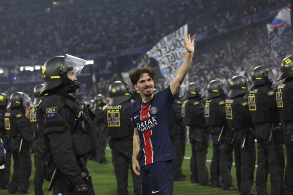 PSG's Vitinha celebrates after the Champions League final soccer match between Paris Saint-Germain and Inter Milan at the Allianz Arena in Munich, Germany, Saturday, May 31, 2025. (AP Photo/Alexandra Beier)