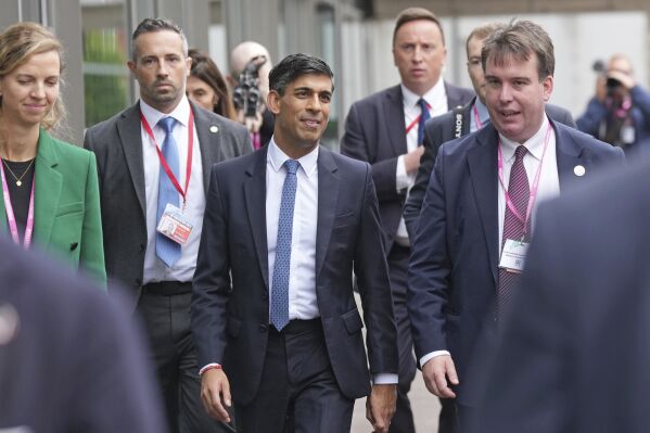 Britain's Prime Minister Rishi Sunak, centre, walks, during the Conservative Party annual conference at the Manchester Central convention complex. in Manchester, England, Monday, Oct. 2, 2023. (Danny Lawson/PA via AP)