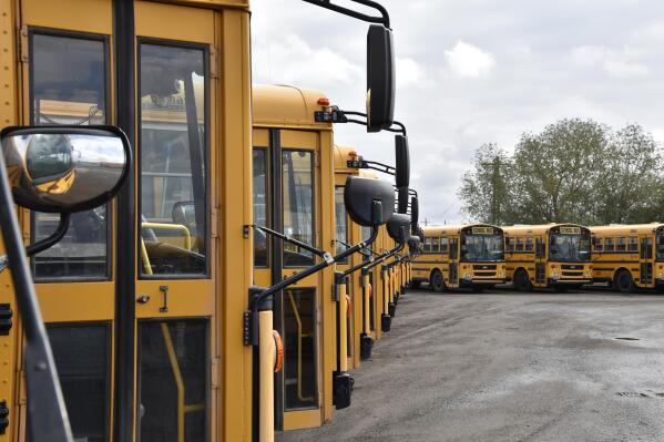 School buses parked in Helena, Mont., ahead of the beginning of the school year, Friday, Aug. 20, 2021. School districts across the country are coping with a shortage of bus drivers, a dilemma that comes even as they struggle to start a new school year during a new surge of the coronavirus pandemic.  (AP Photo/Iris Samuels)