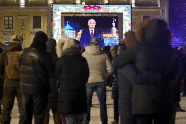 FILE - People watch Russian President Vladimir Putin's New Year's message during celebrations at the Palace Square in St. Petersburg, Russia, on Dec. 31, 2023. (AP Photo/Dmitri Lovetsky, File)