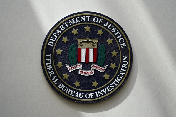 FILE - An FBI seal is seen on a wall on Aug. 10, 2022, in Omaha, Neb. The House was holding a key test vote Wednesday, April 10, 2024, on whether to consider a bill that would reauthorize a crucial national security surveillance program, but the prospects were uncertain amid intense Republican opposition as well as an edict earlier in the day from former President Donald Trump to “kill" the measure. Johnson has called the program “critically important” but has struggled to find a path forward on the issue, which has been plagued by partisan bickering for years. (AP Photo/Charlie Neibergall, File)