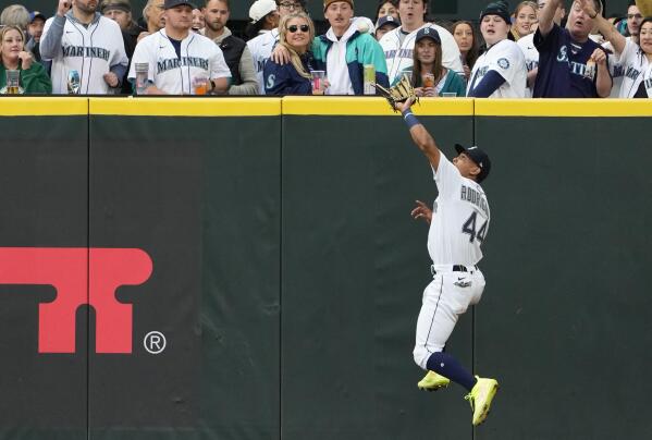 A Seattle Mariners fan wearing a Cal Raleigh jersey with Raleigh's