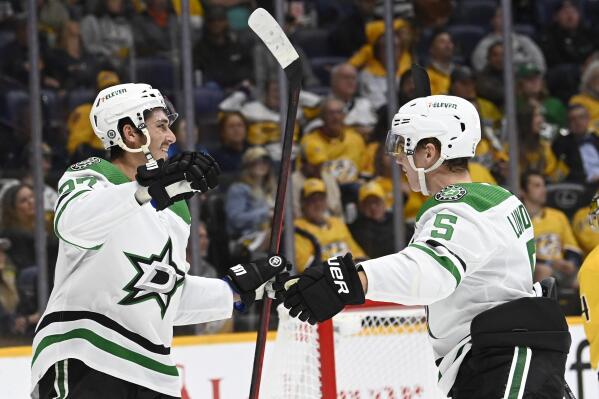 Dallas Stars left wing Mason Marchment (27) celebrates with defenseman Nils Lundkvist (5) after Marchment scored his second goal of the night against the Nashville Predators, during the first period of an NHL hockey game Thursday, Oct. 13, 2022, in Nashville, Tenn. (AP Photo/Mark Zaleski)