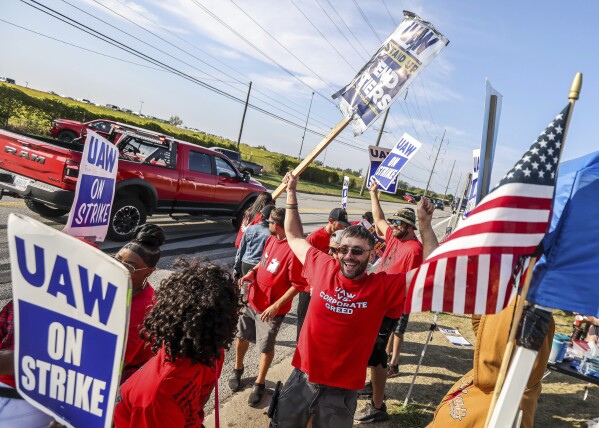 United Auto Workers member Kenneth Carroll, center, of Team 14, dances and cheers on Stickney Avenue outside Stellantis Toledo Assembly Complex on Saturday, Sept. 23, 2023, in Toledo. (Isaac Ritchey/The Blade via AP)