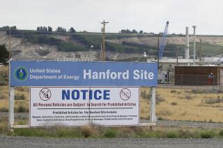 FILE - In this July 9, 2014 file photo, a sign informs visitors of prohibited items on the Hanford Site near Richland, Wash. The U.S. Department of Energy has confirmed that two underground structures at the decommissioned Hanford nuclear reservation in Washington state have been stabilized after they were deemed at risk of collapsing and spreading radioactive contamination into the air. (AP Photo/Ted S. Warren, File)