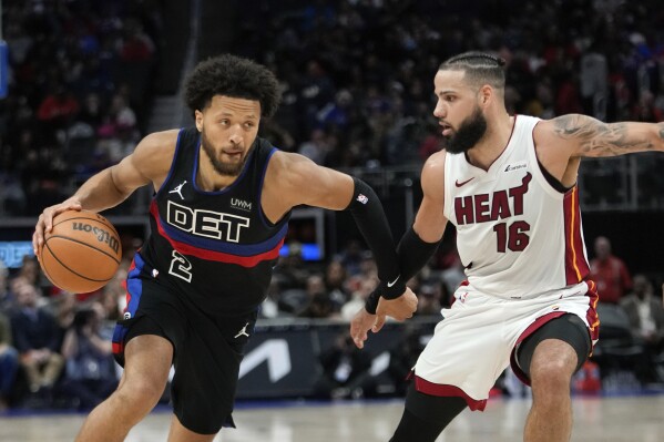 Detroit Pistons guard Cade Cunningham (2) drives on Miami Heat forward Caleb Martin (16) in the second half of an NBA basketball game in Detroit, Friday, March 15, 2024. (AP Photo/Paul Sancya)