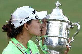 Minjee Lee, of Australia, kisses the Harton S. Semple Trophy after Lee won the final round of the U.S. Women's Open golf tournament at the Pine Needles Lodge & Golf Club in Southern Pines, N.C., on Sunday, June 5, 2022. Minjee Lee, of Australia, won the match. (AP Photo/Steve Helber)