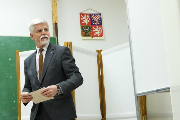 Presidential candidate and retired army Gen. Petr Pavel prepares to cast his vote during presidential election runoff in Cernoucek, Czech Republic, Friday, Jan. 27, 2023. (AP Photo/Petr David Josek)