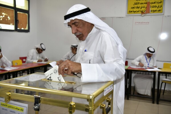 A man casts his vote for the National Assembly elections at Salem Al Nawaf school in Al Riqqa district, Kuwait, Thursday, April 4, 2024. Kuwait votes in its 4th election in as many years in its latest attempt to end political gridlock. (AP Photo/Jaber Abdulkhaleg)