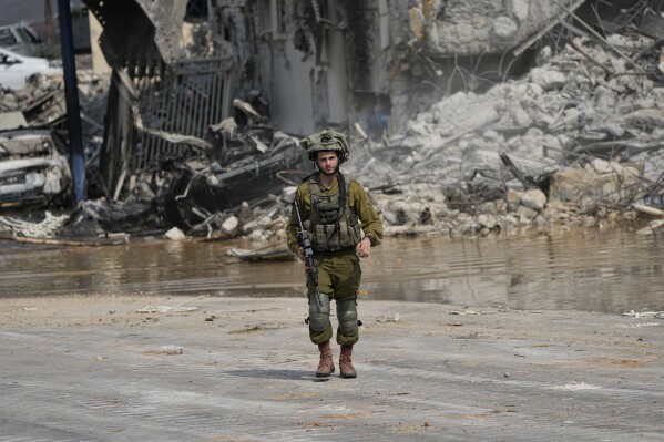An Israeli soldier walks outside a police station that was overrun by Hamas militants on Saturday, in Sderot, Israel, Sunday, Oct.8, 2023. (AP Photo/Ohad Zwigenberg, File)