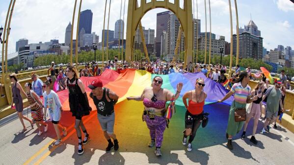 The Pittsburgh Pride parade, celebrating 50 years of Pittsburgh Pride, crosses the Andy Warhol bridge from downtown Pittsburgh, Saturday, June 3, 2023. (AP Photo/Gene J. Puskar)