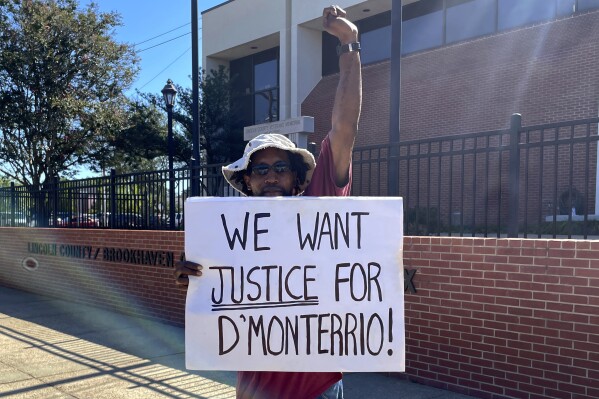 Rayshun Bridges demonstrates outside the Lincoln County Courthouse in Brookhaven, Miss., on Thursday, Aug. 17, 2023, after a judge declared a mistrial for two white men charged in a 2022 attack on D'Monterrio Gibson, a Black employee of FedEx. Prosecutors said they will set a new trial for Gregory Case and his son, Brandon Case, who are accused of shooting at Gibson and chasing his delivery van after Gibson dropped of a package at a home. (AP Photo/Emily Wagster Pettus)