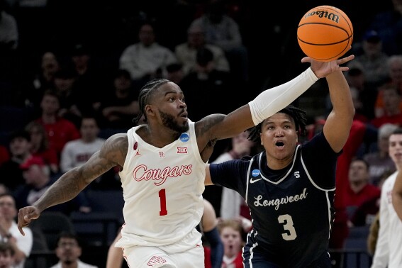 Houston guard Jamal Shead (1) grabs a loose ball away from Longwood guard DA Houston (3) during the first half of a first-round college basketball game in the NCAA Tournament, Friday, March 22, 2024, in Memphis, Tenn. (AP Photo/George Walker IV)