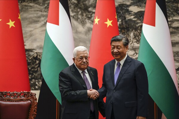 FILE - China's President Xi Jinping, right, and Palestinian President Mahmoud Abbas shake hands after a signing ceremony at the Great Hall of the People in Beijing, June 14, 2023. In June, Chinese President Xi Jinping hosted the Palestinian president in Beijing and invited the Israeli prime minister for an official state visit. Benjamin Netanyahu accepted, and China was on track for a bigger role in the region. Then came the attack, which has made Netanyahu’s trip uncertain and all the more so because of China's stated neutrality on the war. (Jade Gao/Pool Photo via AP, File)