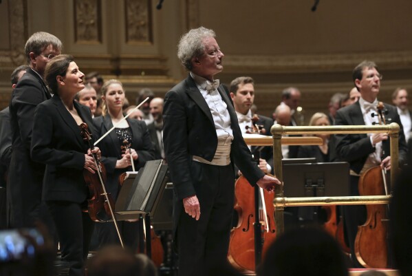 This image released by Carnegie Hall shows Albena Danailova, foreground left, and Franz Welser-Möst after a performance with the Vienna Philharmonic at Carnegie Hall in New York on March 3, 2024. Vienna Philharmonic has 24 female players among 145 members with three vacancies as it tours the United States this week. (Steve J. Sherman/Carnegie Hall via AP)