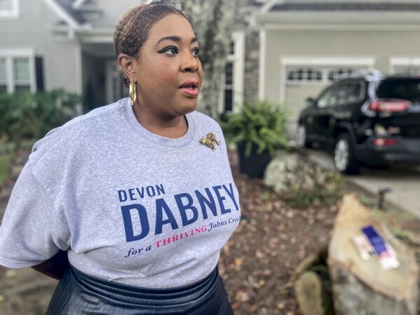 Devon Dabney, a candidate for city council in Johns Creek, Ga., stands outside her home and discusses her candidacy on Monday, Oct. 23, 2023. The contest is nonpartisan and Dabney calls herself an independent, but she faces criticism from some voters in this historically Republican-leaning enclave because she says she has voted for Democrats in the past. The political dynamics in some of Atlanta's suburbs reflect how partisan and cultural divisions have trickled down to local campaigns. (AP Photo/Bill Barrow)