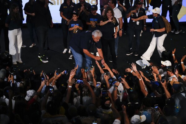 Presidential candidate Jose Raul Mulino, of the Achieving Goals party, shakes hands with supporters after winning the general election, in Panama City, Sunday, May 5, 2024. (AP Photo/Matias Delacroix)
