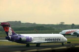 FILE - An Hawaiian Airlines plane taxis for position at Kahalui, Hawaii on the island of Maui on March 24, 2005. Hawaiian Airlines will operate 10 cargo planes for Amazon.com starting next fall under a deal that could eventually involve more planes and give Amazon a 15% stake in the airline, the airline’s parent company, Hawaiian Holdings Inc., said Friday, Oct. 21, 2022.  (AP Photo/Lucy Pemoni, FIle)