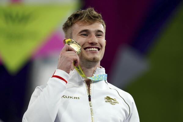England's Jack Laugher with his Gold Medal after the Men's 1m Springboard Final during the Commonwealth Games at Sandwell Aquatics Centre, Birmingham, England, Thursday, Aug. 4, 2022. (Mike Egerton/PA via AP)
