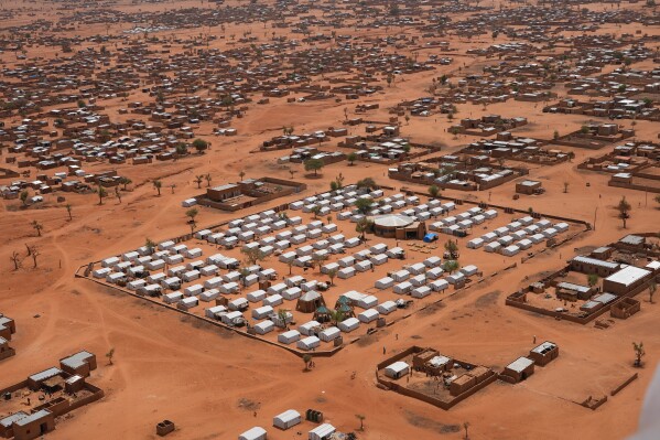 FILE- An aerial view shows a camp of internally displaced people in Djibo, Burkina Faso, May 26, 2022. Videos published by the state-run RTB Television Tuesday, Nov, 28, 2023, showed large groups of people riding motorcycles around a swathe of desert land as they appeared to be running from aerial bombardments. It was not immediately clear the number of civilians and security forces killed during the Sunday attack near Mali's border and involving about 3,000 rebels, according to the broadcaster. The Associated Press could not confirm the authenticity of the videos. (AP Photo/Sam Mednick, File)