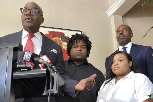 Attorney Roderick Edmond, from left, joined by Treveon Isaiah Taylor, Sr., Jessica Ross and attorney Cory Lynch, speaks during a news conference, Wednesday, Aug. 9, 2023, in Atlanta, announcing a lawsuit against a doctor and Southern Regional Medical Center, a hospital south of Atlanta where Ross went on July 9 to have her son. A doctor used too much force and decapitated Ross's baby during delivery according to the lawsuit filed Wednesday, the attorneys said. (AP Photo/Sudhin Thanawala)