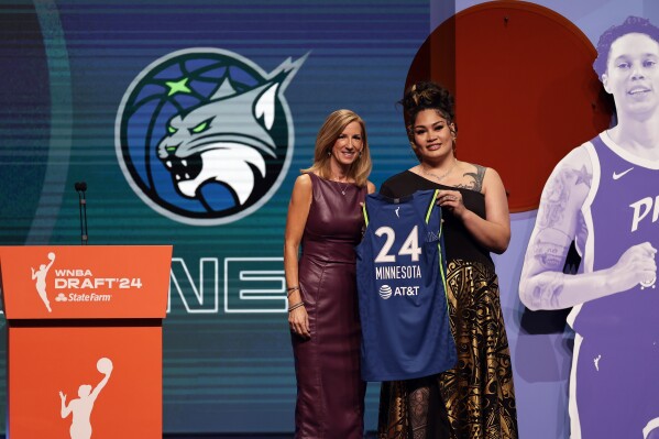 Utah's Alissa Pili, right, poses for a photo with WNBA commissioner Cathy Engelbert after being selected eighth overall by the Minnesota Lynx during the first round of the WNBA basketball draft on Monday, April 15, 2024, in New York. (AP Photo/Adam Hunger)