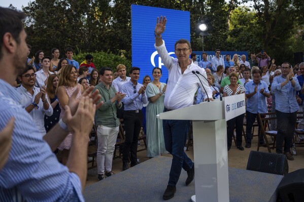 Popular Party candidate Nunez Feijoo arrives at the stage to take part at a campaigning meeting in Barcelona, Spain, Monday, July 17, 2023. The conservative Popular Party candidate for Sunday's general election is mostly unknown outside Spain, but he has been the country's most solid regional leader so far this century and has never lost an election. (AP Photo/Emilio Morenatti)