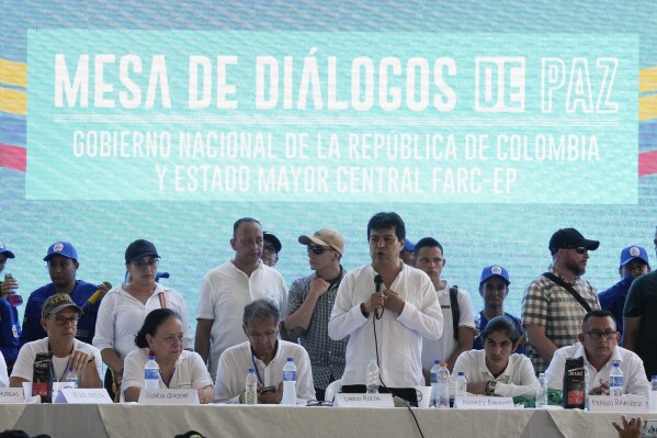 Colombian High Commissioner for Peace Ivan Danilo Rueda, center, speaks during talks with members of the Central General Staff of the Revolutionary Armed Forces of Colombia, FARC, during peace talks in Tibu, Colombia, Sunday, Oct. 8, 2023. The group is an an armed faction of the FARC that broke away and never signed the 2016 peace agreement with the government. (AP Photo/Fernando Vergara)