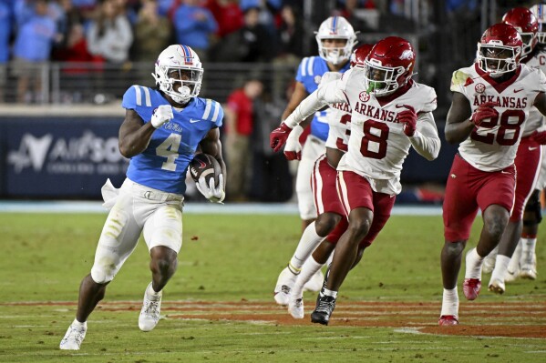 Mississippi running back Quinshon Judkins (4) runs the ball during the second half of an NCAA college football game against Arkansas in Oxford, Miss., Saturday, Oct. 7, 2023. (AP Photo/Thomas Graning)