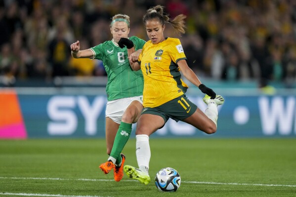 Australia's Mary Fowler, right, vies for the ball with Ireland's Ruesha Littlejohn during the Women's World Cup soccer match between Australia and Ireland at Stadium Australia in Sydney, Australia, Thursday, July 20, 2023. (AP Photo/Rick Rycroft)
