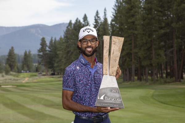 Akshay Bhatia holds the championship trophy after winning the Barracuda Championship golf tournament at the Tahoe Mountain Club in Truckee, Calif., Sunday, July 23, 2023. (AP Photo/Tom R. Smedes)