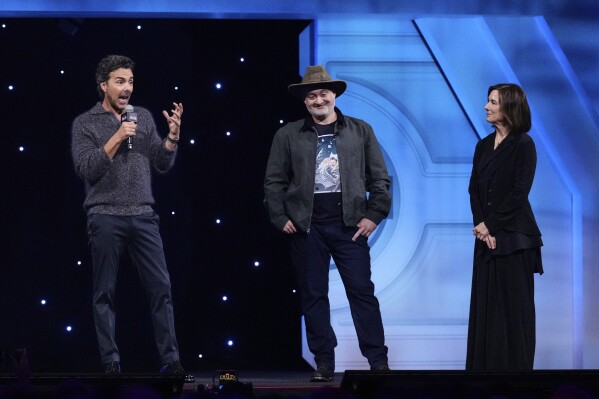 Film director Shawn Levy, left, speaks as director Dave Filoni and producer Kathleen Kennedy listen during a fan convention called the Star Wars Celebration in Chiba, near Tokyo, Friday, April 18, 2025. (AP Photo/Hiro Komae)