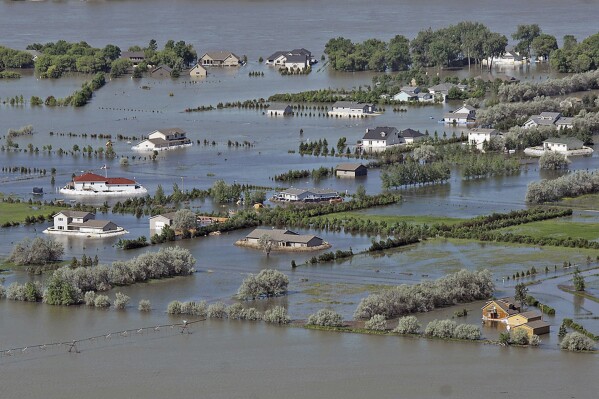 FILE - Homes sit in floodwaters on Hoge Island north of Bismarck, N.D., along the Missouri River flood plain, on June 15, 2011. A federal appeals court has sided with hundreds of landowners along the Missouri River Friday, June 16, 2023, who say the federal government owes them millions for years of flood damage in a case that could be bound for the U.S. Supreme Court. (Tom Stromme/The Bismarck Tribune via AP, File)