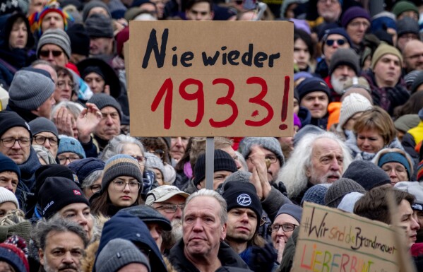 FILE - People gather to protest the far-right Alternative for Germany, or AfD party, and right-wing extremism in Frankfurt am Main, Germany, Jan. 20, 2024. Millions of Germans have joined rallies and even held weekly vigils in their neighborhoods to express their frustration with growing support for far-right populism at the ballot box. Sign reads "Never again 1933," a reference to the year the Nazis came to power. (AP Photo/Michael Probst, File)
