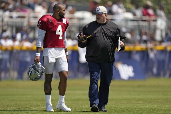 Dallas Cowboys quarterback Dak Prescott, left, talks with head coach Mike McCarthy during the NFL football team's training camp Monday, July 31, 2023, in Oxnard, Calif. (AP Photo/Mark J. Terrill)