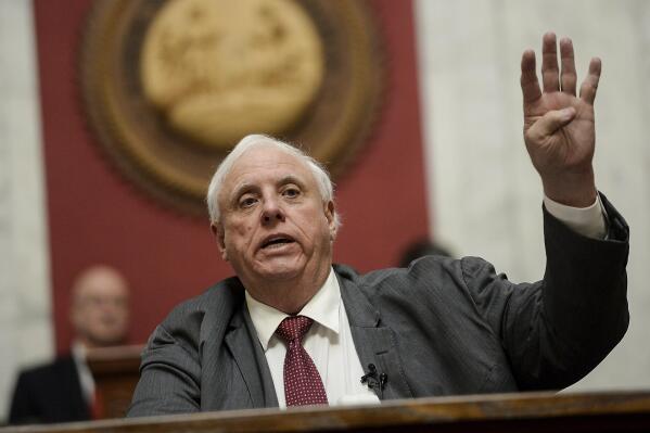 FILE -West Virginia Gov. Jim Justice gives his State of the State speech in the House Chambers, Thursday, Jan. 27, 2022, at the West Virginia State Capitol in Charleston, W.Va. West Virginia Gov. Jim Justice vetoed a bill Wednesday, March 30, 2022 that would have split the massive Department of Health and Human Resources into separate agencies, saying he first wants a review of its “issues, bottlenecks, and inefficiencies.”(Chris Dorst/Charleston Gazette-Mail via AP)
