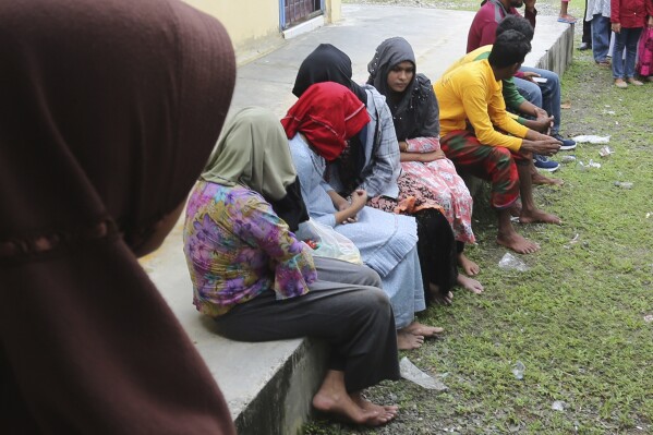 Ethnic Rohingya people rescued from their capsized boat rest at a local government building in Samatiga, Aceh province, Indonesia, Wednesday, March 20, 2024. A wooden boat carrying dozens of Rohingya Muslims capsized about 16 miles (25 Kilometers) from the coastline of Kuala Bubon beach in Indonesia's northernmost province of Aceh on Wednesday. (AP Photo)