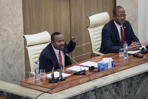 Ethiopia's Prime Minister Abiy Ahmed, left, accompanied by House speaker Tagesse Chafo, right, addresses the parliament in the capital Addis Ababa, Ethiopia Tuesday, Nov. 15, 2022. Abiy said Tuesday that the future status of disputed territory in the western part of the country's Tigray region will be settled according to the Ethiopian constitution, following the signing of a truce earlier this month. (AP Photo)