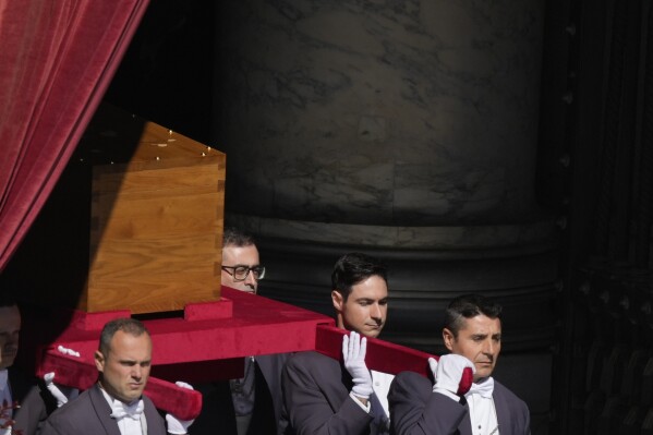 The coffin of Pope Francis is carried out of St Peter's Basilica during his funeral, in St. Peter's Square at the Vatican, Saturday, April 26, 2025. (AP Photo/Gregorio Borgia)
