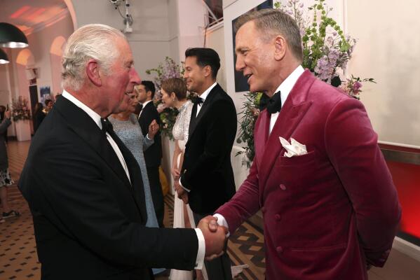 Britain's Prince Charles, left, speaks to British actor Daniel Craig upon arrival for the World premiere of the new film from the James Bond franchise 'No Time To Die', in London, Tuesday, Sept. 28, 2021. (Chris Jackson/Pool Photo via AP)