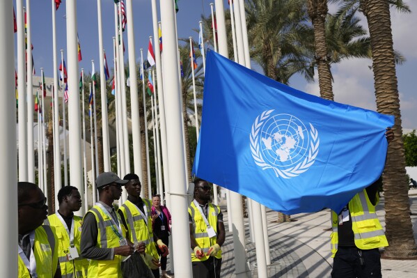 FILE - The United Nations flag is adjusted ahead of the COP28 United Nations climate summit in Dubai, United Arab Emirates, Wednesday, Nov. 29, 2023.  (AP Photo/Rafiq Maqbool, File)