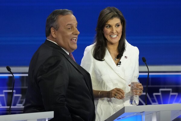 Republican presidential candidates former U.N. Ambassador Nikki Haley talks with former New Jersey Gov. Chris Christie during a break at the Republican presidential primary debate hosted by NBC News, Wednesday, Nov. 8, 2023. (AP Photo/Rebecca Blackwell)