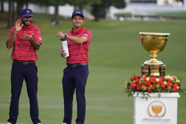 FILE - Kevin Kisner, right, and Max Homa celebrate a win over the International team in match play at the Presidents Cup golf tournament at the Quail Hollow Club, Sunday, Sept. 25, 2022, in Charlotte, N.C. Kisner stopped playing in June to work on his game and spend more time with family. He returns to the PGA Tour this week. (AP Photo/Julio Cortez, File)